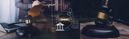Justice and law concept.Male judge in a courtroom with the gavel, working with, computer and docking...