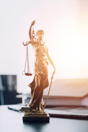 justice and law concept.Male judge in a courtroom on wooden table and Counselor or Male lawyer working in office. Legal law, advice and justice concept.の写真素材