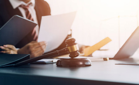 justice and law concept.Male judge in a courtroom on wooden table and Counselor or Male lawyer working in office. Legal law, advice and justice concept.の写真素材