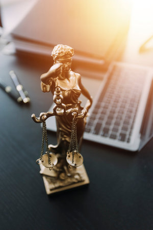 justice and law concept.Male judge in a courtroom on wooden table and Counselor or Male lawyer working in office. Legal law, advice and justice concept.の写真素材