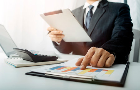 Business team present. professional investor working new start up project. Finance managers meeting.Digital tablet docking screen computer design smart phone using, in morning lightの写真素材