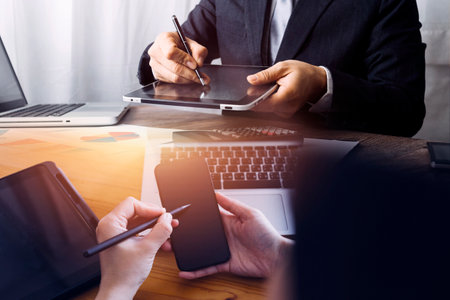 Business partnership coworkers using a tablet to analysis graph company financial budget report and...