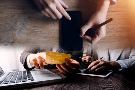 Business team present. professional investor working new start up project. Finance managers meeting.Digital tablet docking screen computer design smart phone using, in morning lightの写真素材