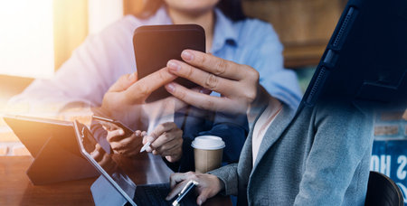 Business team present. professional investor working new start up project. Finance managers meeting.Digital tablet docking screen computer design smart phone using, in morning lightの写真素材