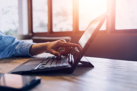 businesswoman hand working with laptop computer, tablet and smart phone in modern office with...