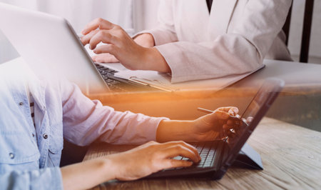 businesswoman hand working with laptop computer, tablet and smart phone in modern office with...