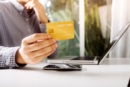 Woman hand using mobile smart phone, online payment, banking and online shopping at the home.の写真素材