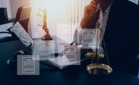 Business and lawyers discussing contract papers with brass scale on desk in office. Law, legal services, advice, justice and law concept picture with film grain effectの写真素材