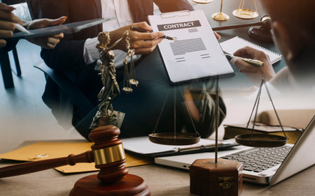 Business and lawyers discussing contract papers with brass scale on desk in office. Law, legal...