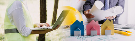 Construction engineer working at blueprint to build large commercial buildings in office....