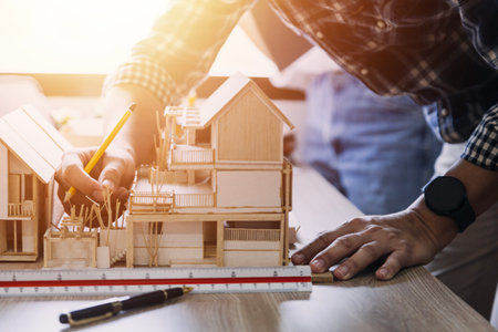 Construction engineer working at blueprint to build large commercial buildings in office....