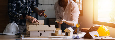 Construction engineer working at blueprint to build large commercial buildings in office....