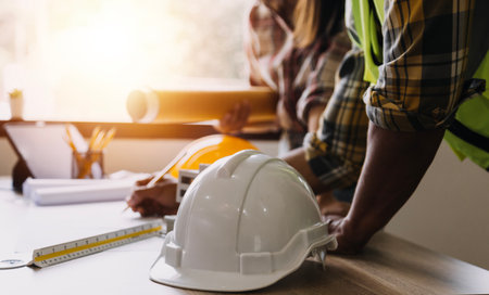 Construction engineer working at blueprint to build large commercial buildings in office....