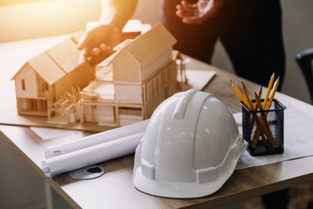 Construction engineer working at blueprint to build large commercial buildings in office....