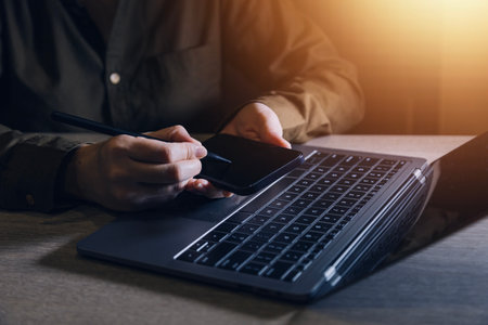 businesswoman hand working with laptop computer, tablet and smart phone in modern office with...