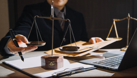 Business and lawyers discussing contract papers with brass scale on desk in office. Law, legal...