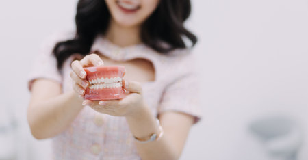 Stomatology concept, partial portrait of girl with strong white teeth looking at camera and smiling,...