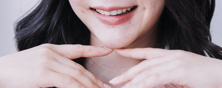 Stomatology concept, partial portrait of girl with strong white teeth looking at camera and smiling,...