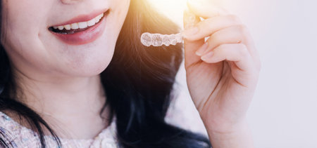 Stomatology concept, partial portrait of girl with strong white teeth looking at camera and smiling,...