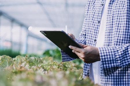 Futuristic businessman farms vegetables and crops using modern AI technology using mobile phones,...