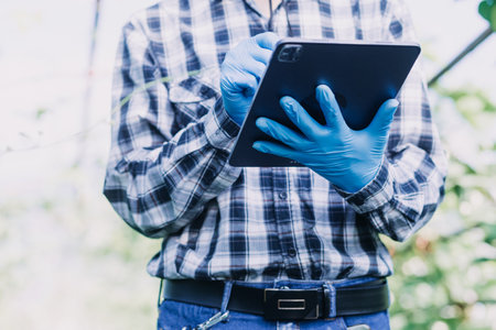 Futuristic businessman farms vegetables and crops using modern AI technology using mobile phones,...