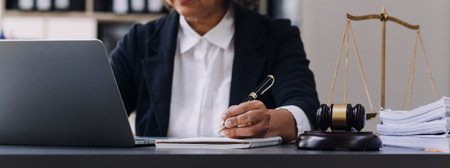 Male lawyer working with contract papers and wooden gavel on tabel in courtroom. justice and law ,attorney, court judge, concept.の写真素材