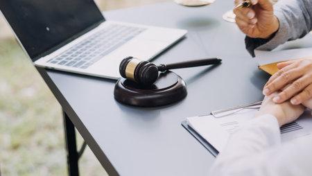 law books and scales of justice on desk in library of law firm. jurisprudence legal education...