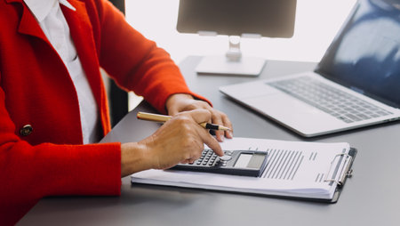 Businessman and team analyzing financial statement Finance task. with smart phone and laptop and...