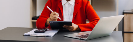 businesswoman hand working with laptop computer, tablet and smart phone in modern office with...