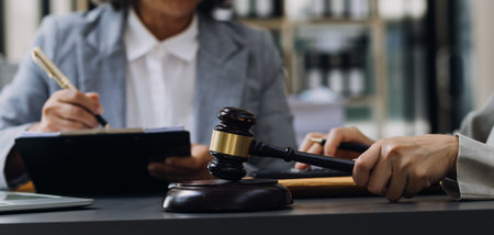 Justice and law concept.Male judge in a courtroom with the gavel, working with, computer and docking...