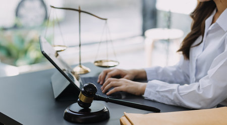 Male lawyer working with contract papers and wooden gavel on tabel in courtroom. justice and law ,attorney, court judge, concept.の写真素材