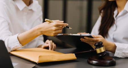 Male lawyer working with contract papers and wooden gavel on tabel in courtroom. justice and law ,attorney, court judge, concept.の写真素材