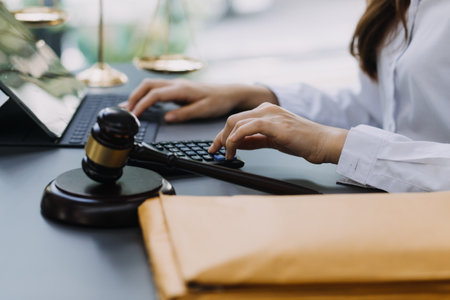 Male lawyer working with contract papers and wooden gavel on tabel in courtroom. justice and law ,attorney, court judge, concept.の写真素材