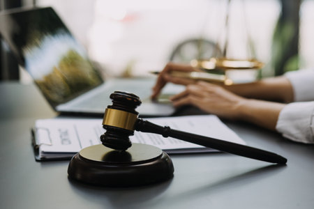 Male lawyer working with contract papers and wooden gavel on tabel in courtroom. justice and law...