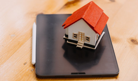 Discussion with a real estate agent, House model with agent and customer discussing for the contract to buy, get insurance or loan real estate or property.の写真素材