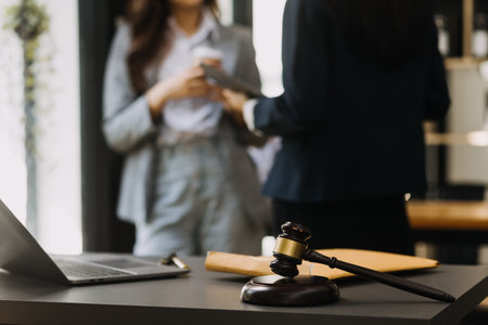 Male lawyer working with contract papers and wooden gavel on tabel in courtroom. justice and law...