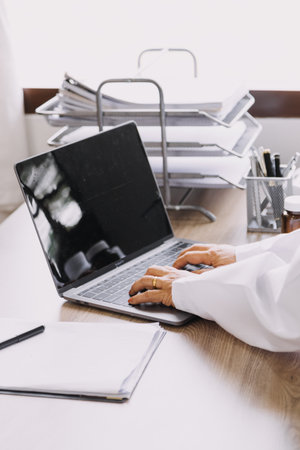 Homecare nursing service and elderly people cardiology healthcare. Close up of young hispanic female doctor nurse check mature caucasian man patient heartbeat using stethoscope during visitの写真素材