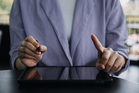 Asian colleagues man and woman discussing and working with laptop computer on office desk in the officeの写真素材