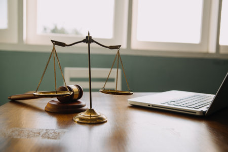 Business and lawyers discussing contract papers with brass scale on desk in office. Law, legal services, advice, justice and law concept picture with film grain effectの写真素材