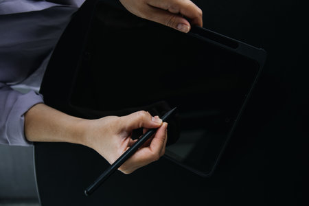 Asian colleagues man and woman discussing and working with laptop computer on office desk in the officeの写真素材