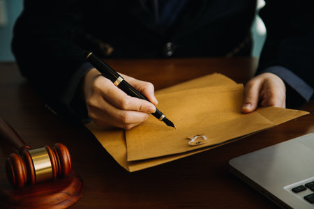 Business and lawyers discussing contract papers with brass scale on desk in office. Law, legal services, advice, justice and law concept picture with film grain effectの写真素材