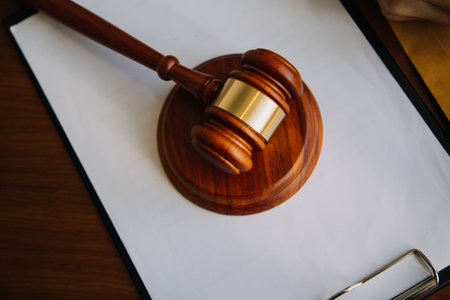 Business and lawyers discussing contract papers with brass scale on desk in office. Law, legal services, advice, justice and law concept picture with film grain effectの写真素材