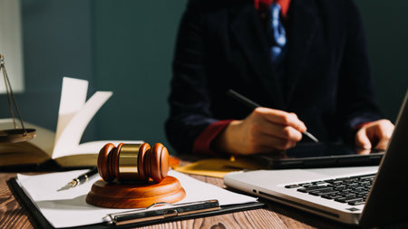 Business and lawyers discussing contract papers with brass scale on desk in office. Law, legal services, advice, justice and law concept picture with film grain effectの写真素材