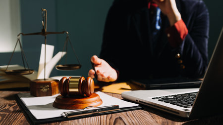 Business and lawyers discussing contract papers with brass scale on desk in office. Law, legal services, advice, justice and law concept picture with film grain effectの写真素材