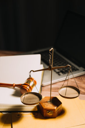 Business and lawyers discussing contract papers with brass scale on desk in office. Law, legal services, advice, justice and law concept picture with film grain effectの写真素材