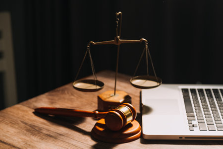 Business and lawyers discussing contract papers with brass scale on desk in office. Law, legal services, advice, justice and law concept picture with film grain effectの写真素材