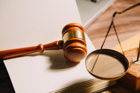 Business and lawyers discussing contract papers with brass scale on desk in office. Law, legal services, advice, justice and law concept picture with film grain effectの写真素材