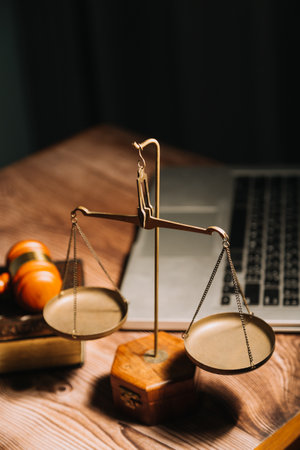Business and lawyers discussing contract papers with brass scale on desk in office. Law, legal services, advice, justice and law concept picture with film grain effectの写真素材