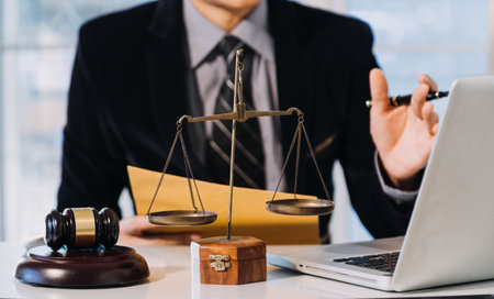 Business and lawyers discussing contract papers with brass scale on desk in office. Law, legal services, advice, justice and law conceptの写真素材