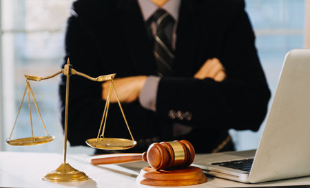 Business and lawyers discussing contract papers with brass scale on desk in office. Law, legal services, advice, justice and law conceptの写真素材
